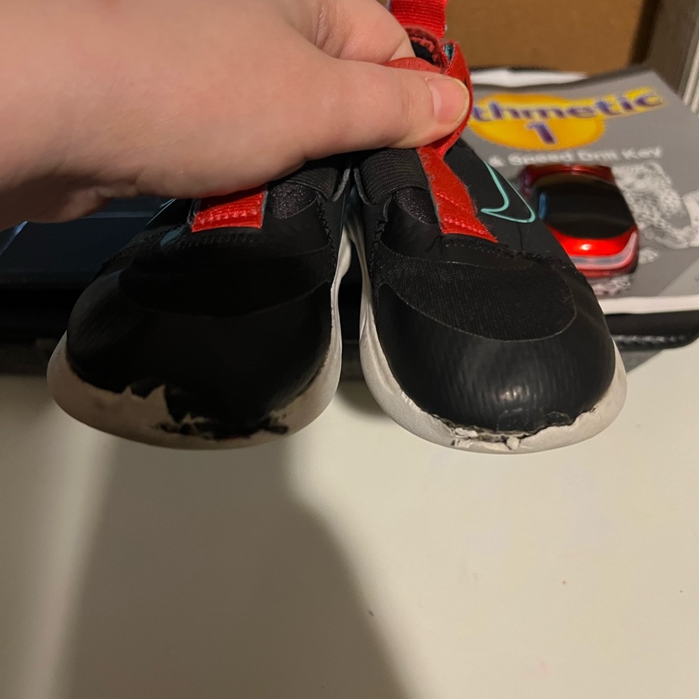 Nike Kids Black Slip-On Sneakers with Red Straps and Teal Swoosh